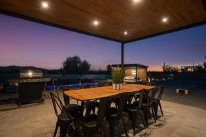 a wooden table and chairs on a patio at Desert Oasis in Joshua Tree