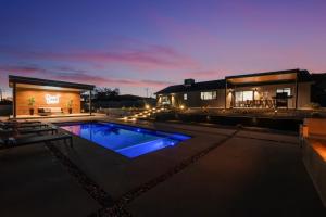 a villa with a swimming pool at night at Desert Oasis in Joshua Tree