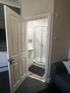 a door leading to a bathroom with a shower at Matipa-Given Apartments Eastleigh Southampton in Eastleigh