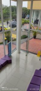 a lobby of a building with purple cushions on the floor at CITRA INN in Tangerang