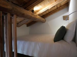 a bed in a room with wooden ceilings at La ferme d'Hauteluce - Chambre d'hôtes in Hauteluce