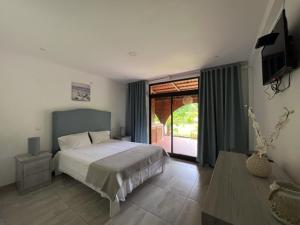Postel nebo postele na pokoji v ubytování Casa dos Arcos
