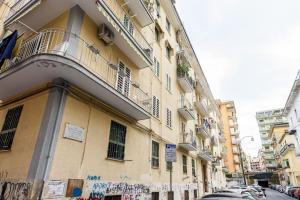 a building with graffiti on the side of a street at Vomero Dream Naples in Naples