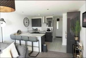 a kitchen with a island in the middle of a room at Contemporary Seaside Apartment in Bangor