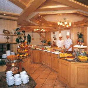 two chefs standing in a kitchen preparing food at App Steenbok 516 Kleinwalsertal in Mittelberg
