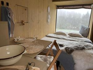 a bedroom with a bed and a table and a window at Posed v Moravském Berouně in Moravský Beroun