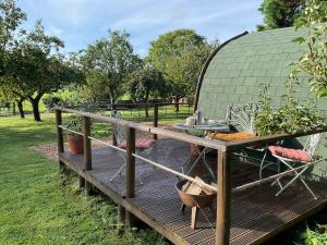 a gazebo with a table and chairs on a wooden deck at Secluded Cosy Luxury Pod in Shrewsbury