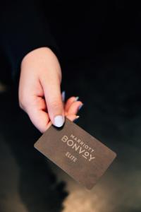 a hand holding a brown card with the word money at AC Hotel by Marriott Denver Downtown in Denver