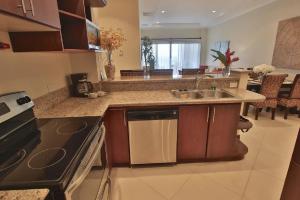 a kitchen with a sink and a stove at Playa Flamingo - 2 BR condo with great ocean views - FLAMINGO TOWERS 25 in Playa Flamingo