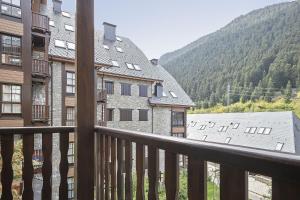 a balcony with a view of buildings and mountains at Luderna - Apartamento Val de Ruda B15 Baretja in Baqueira-Beret