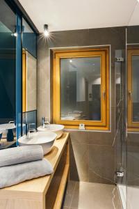 a bathroom with two sinks and a shower at Chalet M in Val di Zoldo