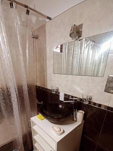 a bathroom with a sink and a shower at Chalet " La Maruca " in Villa Carlos Paz