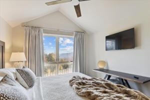 a bedroom with a bed and a large window at Trapp Villa 618 in Stowe