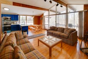 a living room with two couches and a table at Londonderry Vacation Home with Deck and Gas Grill! in Londonderry