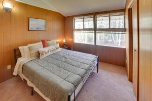 a bedroom with a large bed and a window at Londonderry Vacation Home with Deck and Gas Grill! in Londonderry