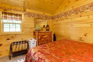 a bedroom with a bed in a log cabin at Idyllic Florence Cabin with Grill and Creek Views in Florence