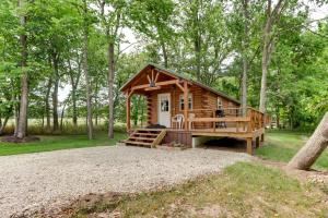 a small log cabin in the woods with a porch at Idyllic Florence Cabin with Grill and Creek Views in Florence