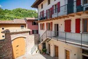 a group of buildings with red doors and balconies at GARDA BALDO APARTMENTS in Nago-Torbole