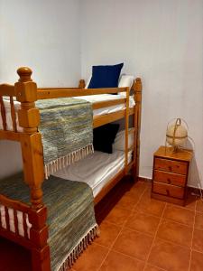a room with two bunk beds and a night stand at La Molinera Rustic in Cártama