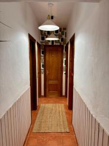 an empty hallway with a door and a rug at La Molinera Rustic in Cártama