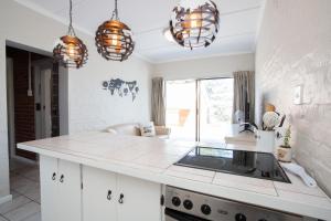 a kitchen with a counter and pendant lights at Shepherd's Rest in Mossel Bay +29 photos