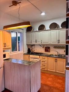 a kitchen with white cabinets and a counter top at La Molinera Rustic in Cártama