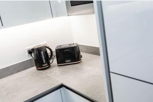 a kitchen counter with a toaster and a toaster at Modern Apartment Portrush in Portrush