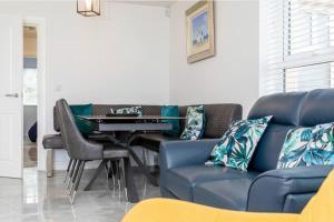 a living room with a couch and a table at Modern Apartment Portrush in Portrush