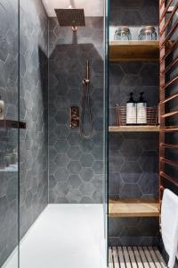 a bathroom with a shower with gray tiles at Jane Austen's Family Home in Bath from 1801 to 1805 in Bath