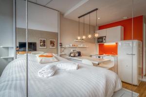 1 Schlafzimmer mit einem großen weißen Bett und einer Küche in der Unterkunft Duployé N3 in Grenoble