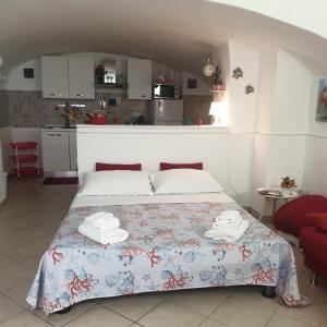 a bedroom with a bed with two towels on it at Ursino holiday apartment in Catania