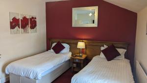 a hotel room with two beds and a mirror at The King's Arms in Boston