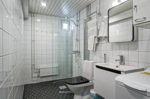 a white bathroom with a toilet and a sink at Forenom Serviced Apartments Espoo Tapiola in Espoo +12 photos