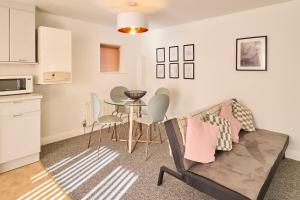 a living room with a couch and a table at Host & Stay - King's Corner in Canterbury