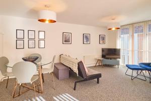 sala de estar con mesa, sillas y TV en Host & Stay - King's Corner en Canterbury