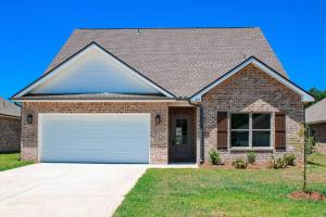 a brown brick house with a white garage at Charming Brand New Home in Foley in Foley