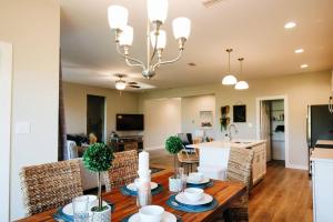 a dining room and living room with a table and chairs at Charming Brand New Home in Foley in Foley