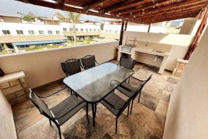 een tafel en stoelen op een balkon met een keuken bij Nueva y hermosa Casa familiar, relajate y disfruta in Chiconcuac