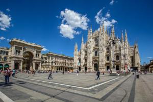 a group of people walking in front of a cathedral at Leo’s Home in Sesto San Giovanni