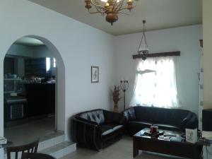 a living room with a couch and a table at Hotel Filoxenia in Aegiali
