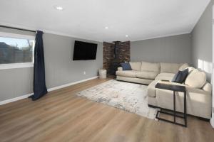 a living room with a couch and a television at Spacious home near Anschutz/DIA in Aurora