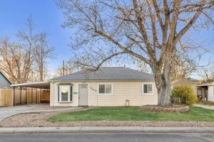 a house with a tree in the front yard at Spacious home near Anschutz/DIA in Aurora