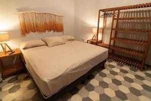 a bedroom with a bed and two lamps and a shelf at Casa del Desierto in Guadalajara