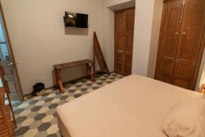 a bedroom with a bed and a table and a chair at Casa del Desierto in Guadalajara