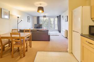 a kitchen and living room with a table and a couch at Host & Stay - Bingley Court in Canterbury