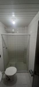 a bathroom with a shower with a toilet and a sink at Pousada Elefantinho in São Pedro da Aldeia