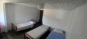 a room with two beds and two bunk beds at Pousada Elefantinho in São Pedro da Aldeia