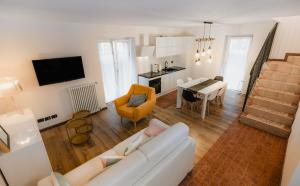 a living room with a white couch and a table at Pinzolo Ski Lodge Retreat in Pinzolo