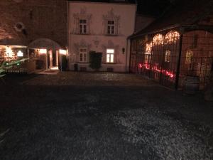 an empty courtyard of a building at night at Hotel zur Brücke in Herzogenrath