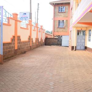 an empty parking lot in front of a building at @princess Dee in Meru